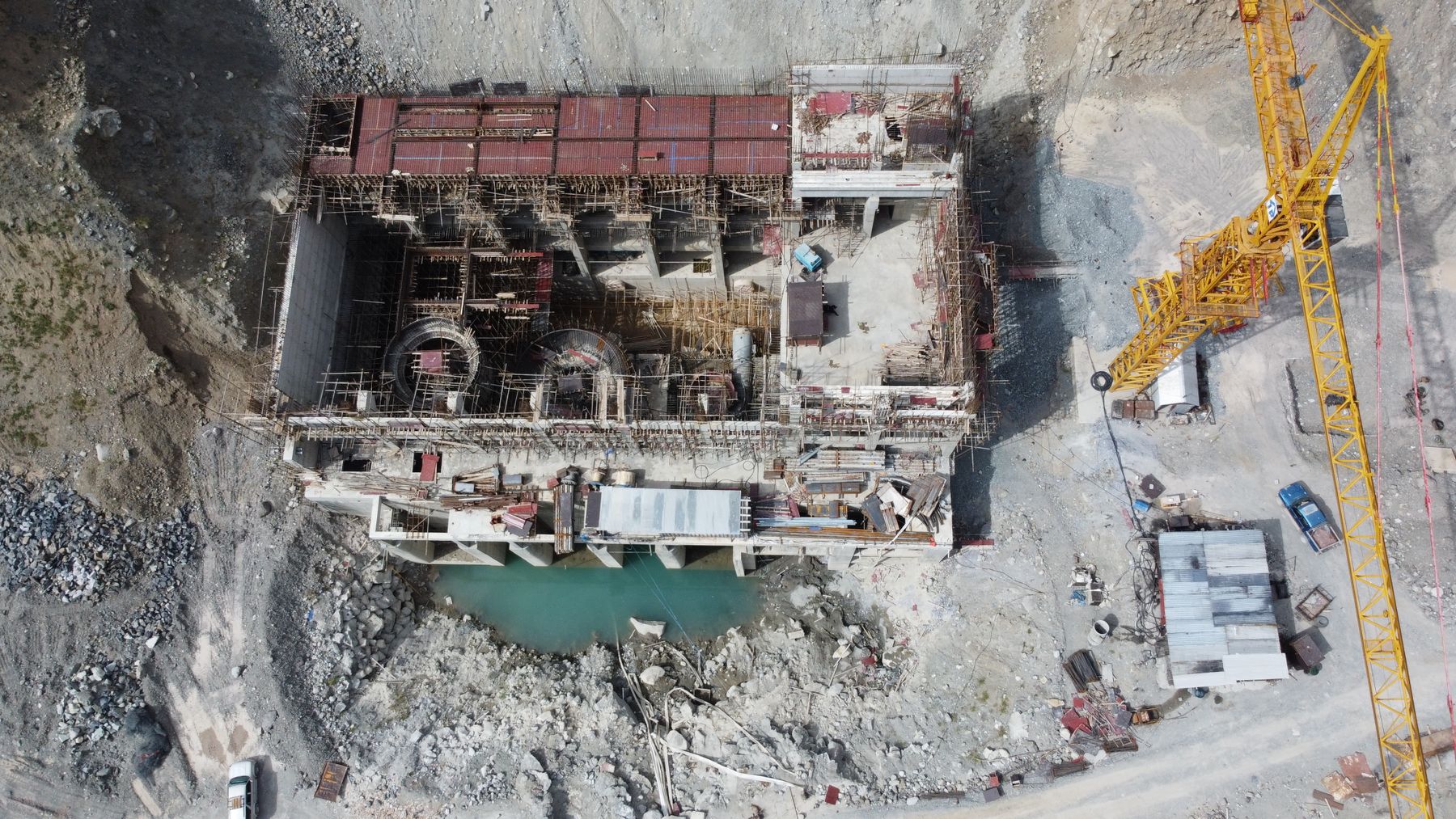 Drone view of an active construction site with a tower crane