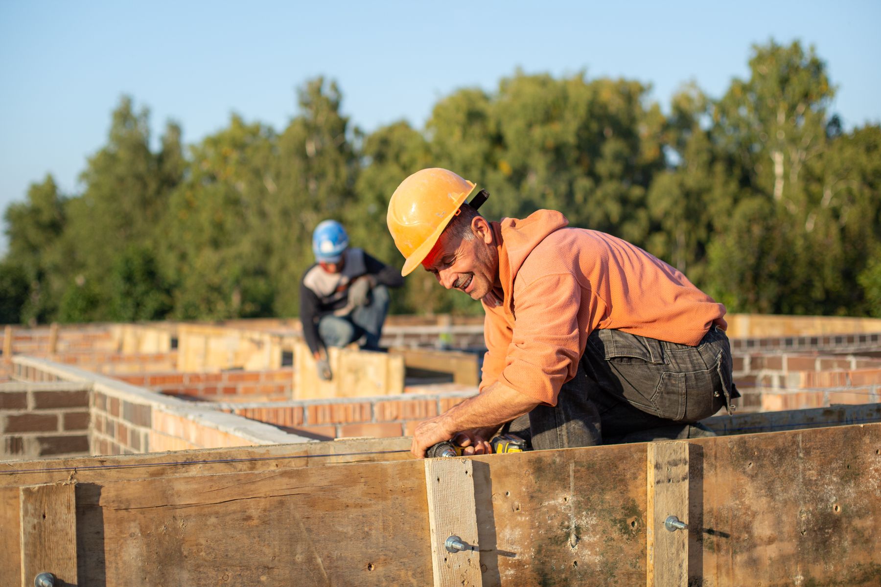 Construction workers in safety helmets working on a building site