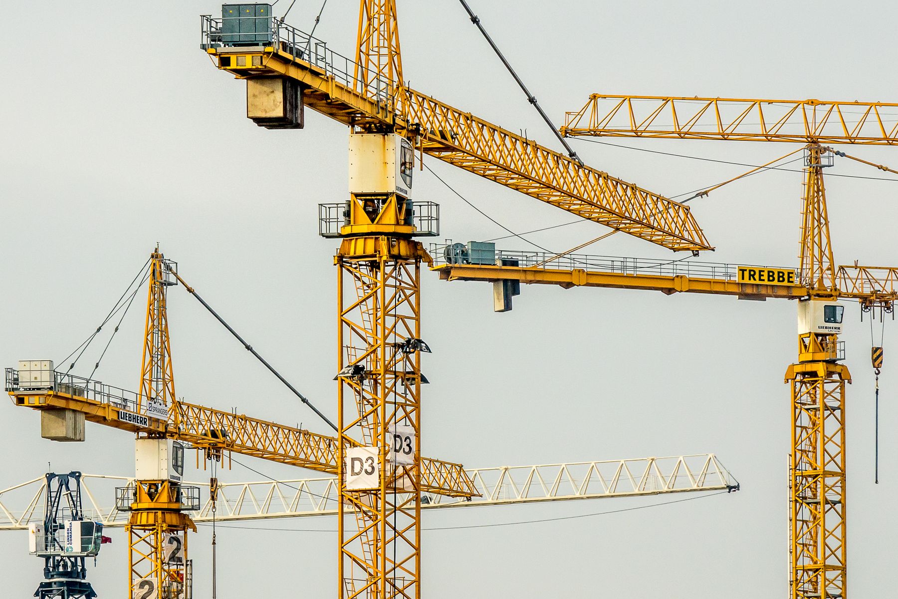 Yellow tower cranes on a large construction site